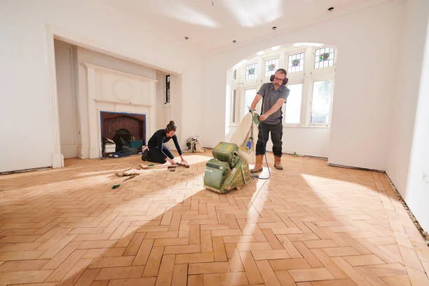 Professional commercial floor care team performing stripping and waxing on hardwood flooring in a Bay Area facility.